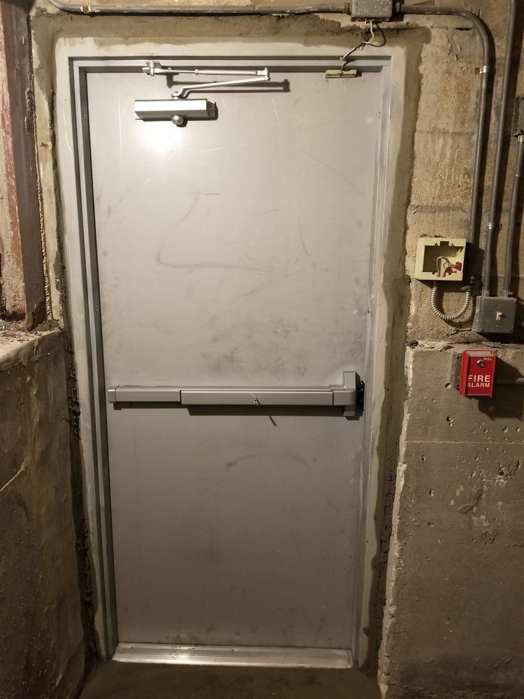 New hollow metal door with panic bar and closer in the same block-wall opening